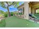 Backyard featuring a putting green, grill, and lounge seating, perfect for outdoor fun and relaxation at 4636 Riva De Romanza St, Las Vegas, NV 89135