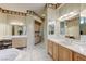 Bright bathroom featuring double vanities, decorative accents, and a glass shower enclosure at 4636 Riva De Romanza St, Las Vegas, NV 89135