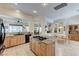 Open floor plan, granite countertops, stainless steel appliances, and views into other living spaces at 4636 Riva De Romanza St, Las Vegas, NV 89135