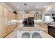 Bright kitchen featuring a granite island with a cooktop, stainless steel appliances, and wood cabinets at 4636 Riva De Romanza St, Las Vegas, NV 89135