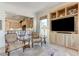 Comfortable living room features built-in shelving and a view of the kitchen through an open concept at 4636 Riva De Romanza St, Las Vegas, NV 89135