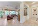 Cozy living room with tile flooring, a decorative stone accent wall, and lots of natural light at 4636 Riva De Romanza St, Las Vegas, NV 89135