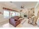 Spacious living room with stone fireplace, plush seating, and views of the backyard at 4636 Riva De Romanza St, Las Vegas, NV 89135