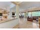 Open concept living and dining area with tile flooring, granite countertops, and lots of natural light at 4636 Riva De Romanza St, Las Vegas, NV 89135
