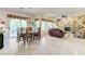 Open-concept living and dining area with tile flooring, abundant natural light, and stylish decor at 4636 Riva De Romanza St, Las Vegas, NV 89135