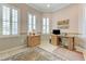 Comfortable office with a tile floor, several large windows, and built-in desk and storage at 4636 Riva De Romanza St, Las Vegas, NV 89135