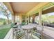 Inviting covered patio area with comfortable seating, perfect for outdoor dining and enjoying the serene surroundings at 4636 Riva De Romanza St, Las Vegas, NV 89135