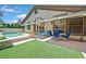 The backyard offers a patio with lounge chairs, a dining table, and a swimming pool with an attached spa at 4724 Stavanger Ln, Las Vegas, NV 89147