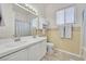 Traditional bathroom featuring a dual-sink vanity and a shower-tub combination at 4724 Stavanger Ln, Las Vegas, NV 89147