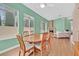 Bright dining area featuring hardwood floors, a wooden table, and plenty of natural light at 4724 Stavanger Ln, Las Vegas, NV 89147