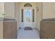 Close-up of the front door with decorative glass, sidelights, and textured stucco walls at 4724 Stavanger Ln, Las Vegas, NV 89147