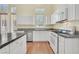 Kitchen featuring white cabinets, granite countertops, and stainless steel appliances at 4724 Stavanger Ln, Las Vegas, NV 89147