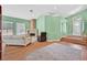 Open-concept living room with a fireplace, hardwood floors, and an entryway at 4724 Stavanger Ln, Las Vegas, NV 89147