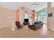 Bright living area featuring hardwood floors, comfortable seating, and a vaulted ceiling at 4724 Stavanger Ln, Las Vegas, NV 89147