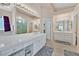 Bright and spacious main bathroom with large vanity, soaking tub, and glass-enclosed shower at 4724 Stavanger Ln, Las Vegas, NV 89147
