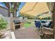 The patio has a built-in grill, seating area, and retractable awning, creating a perfect space for outdoor gatherings at 4724 Stavanger Ln, Las Vegas, NV 89147