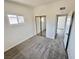 Bright bedroom featuring plush gray carpeting, mirrored closet, and a window for natural light at 4924 Carmen Blvd, Las Vegas, NV 89108