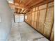 Spacious garage featuring exposed wood rafters, concrete floors, and a secure roll-up door at 4924 Carmen Blvd, Las Vegas, NV 89108