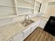 Close-up of kitchen counter with stainless steel sink and bright white cabinets at 4924 Carmen Blvd, Las Vegas, NV 89108
