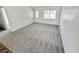 Inviting living room with neutral carpet and fresh paint, leading to other areas of the home at 4924 Carmen Blvd, Las Vegas, NV 89108