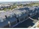Modern townhomes with attached garages feature community streets and desert surroundings at 494 Mahogany Ridge St, Las Vegas, NV 89138