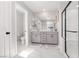 Clean, modern bathroom with dual vanities, a large mirror, and a separate shower area at 494 Mahogany Ridge St, Las Vegas, NV 89138