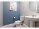 A half bathroom with blue walls and a pedestal sink at 494 Mahogany Ridge St, Las Vegas, NV 89138