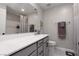 A bathroom featuring a large mirror, grey cabinets, and white countertops at 494 Mahogany Ridge St, Las Vegas, NV 89138