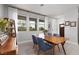 Bright dining room featuring wood table, gray chairs, and three large windows offering an abundance of natural light at 494 Mahogany Ridge St, Las Vegas, NV 89138