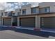 Modern townhome exteriors showcasing contemporary architecture and individual garage doors at 494 Mahogany Ridge St, Las Vegas, NV 89138