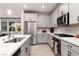 A modern kitchen featuring stainless steel appliances, light grey cabinets, and white countertops at 494 Mahogany Ridge St, Las Vegas, NV 89138