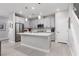 Modern kitchen with white cabinets, stainless steel appliances, island with seating, and hardwood floors at 494 Mahogany Ridge St, Las Vegas, NV 89138