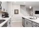 A modern kitchen with stainless steel appliances, light grey cabinets, and white countertops at 494 Mahogany Ridge St, Las Vegas, NV 89138