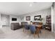 Spacious living room with gray sofa, wood floors, and dining area creating a comfortable and inviting atmosphere at 494 Mahogany Ridge St, Las Vegas, NV 89138