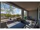 Spacious covered patio with outdoor seating, grill, and views of trees and surrounding community at 494 Mahogany Ridge St, Las Vegas, NV 89138