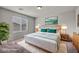 Cozy bedroom with stylish bedside tables, soft bedding and leafy greenery at 5232 Mountain Garland Ln, North Las Vegas, NV 89081
