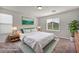 Comfortable bedroom with neutral decor, soft carpet, and serene artwork at 5232 Mountain Garland Ln, North Las Vegas, NV 89081