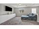 Relaxing bonus room features soft carpet, modern furniture and ample natural light at 5232 Mountain Garland Ln, North Las Vegas, NV 89081