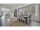 Open-concept dining room with tiled floors, seating for six, and natural light at 5232 Mountain Garland Ln, North Las Vegas, NV 89081