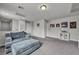 Upstairs living room with a large sectional sofa, neutral carpet and natural lighting at 5232 Mountain Garland Ln, North Las Vegas, NV 89081