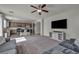 Open concept living space with plush gray couches and spacious kitchen with bar seating at 5232 Mountain Garland Ln, North Las Vegas, NV 89081