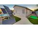 Backyard showcases solar panels, an artificial green and sidewalk access to the pool at 528 Lavina Ct, Las Vegas, NV 89123