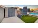 Backyard with artificial green, storage shed, and solar panels by the pool at 528 Lavina Ct, Las Vegas, NV 89123