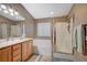 Bright bathroom features a soaking tub, a glass shower, dual sinks, and plenty of lighting at 528 Lavina Ct, Las Vegas, NV 89123