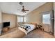 Cozy bedroom features a ceiling fan, plush carpet, and dual windows that brighten the room at 528 Lavina Ct, Las Vegas, NV 89123
