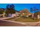 Inviting home featuring a lush lawn, mature trees, and manicured landscaping in a desirable neighborhood at 528 Lavina Ct, Las Vegas, NV 89123