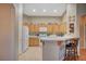 Well-lit kitchen with breakfast bar, natural cabinets, and neutral countertops at 528 Lavina Ct, Las Vegas, NV 89123