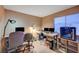Bright home office features carpet flooring and two workstations for work and study at 528 Lavina Ct, Las Vegas, NV 89123