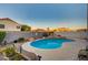 Backyard pool with rock waterfall feature surrounded by mature landscaping and lush plants at 528 Lavina Ct, Las Vegas, NV 89123