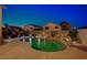 Resort-style pool with rock waterfall and colorful lighting, creating a luxurious and relaxing backyard oasis at 528 Lavina Ct, Las Vegas, NV 89123